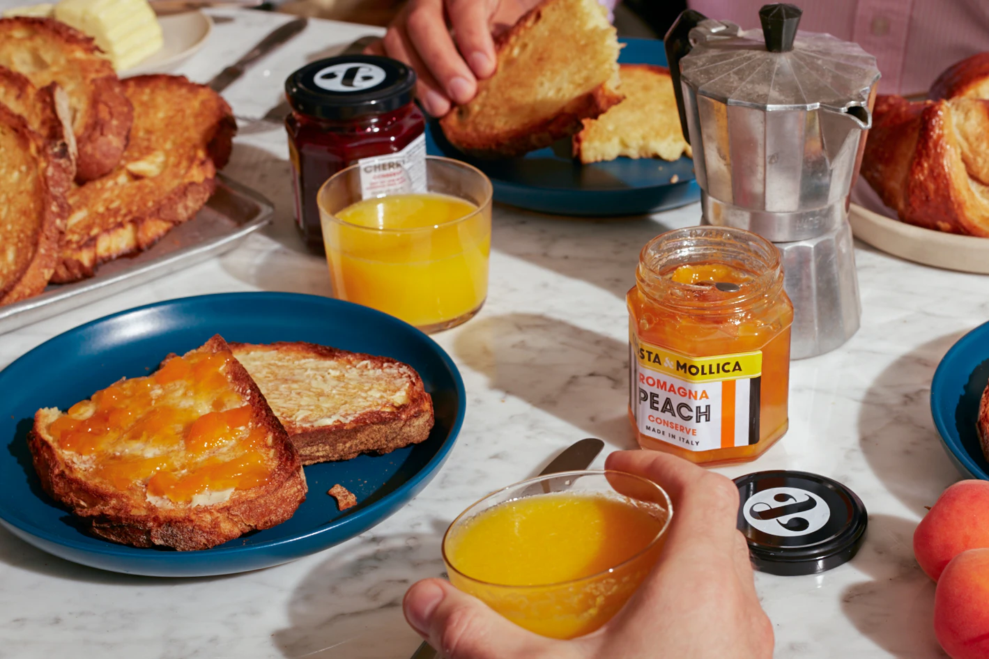 A breakfast table with a toast spread with Peach Conserve.