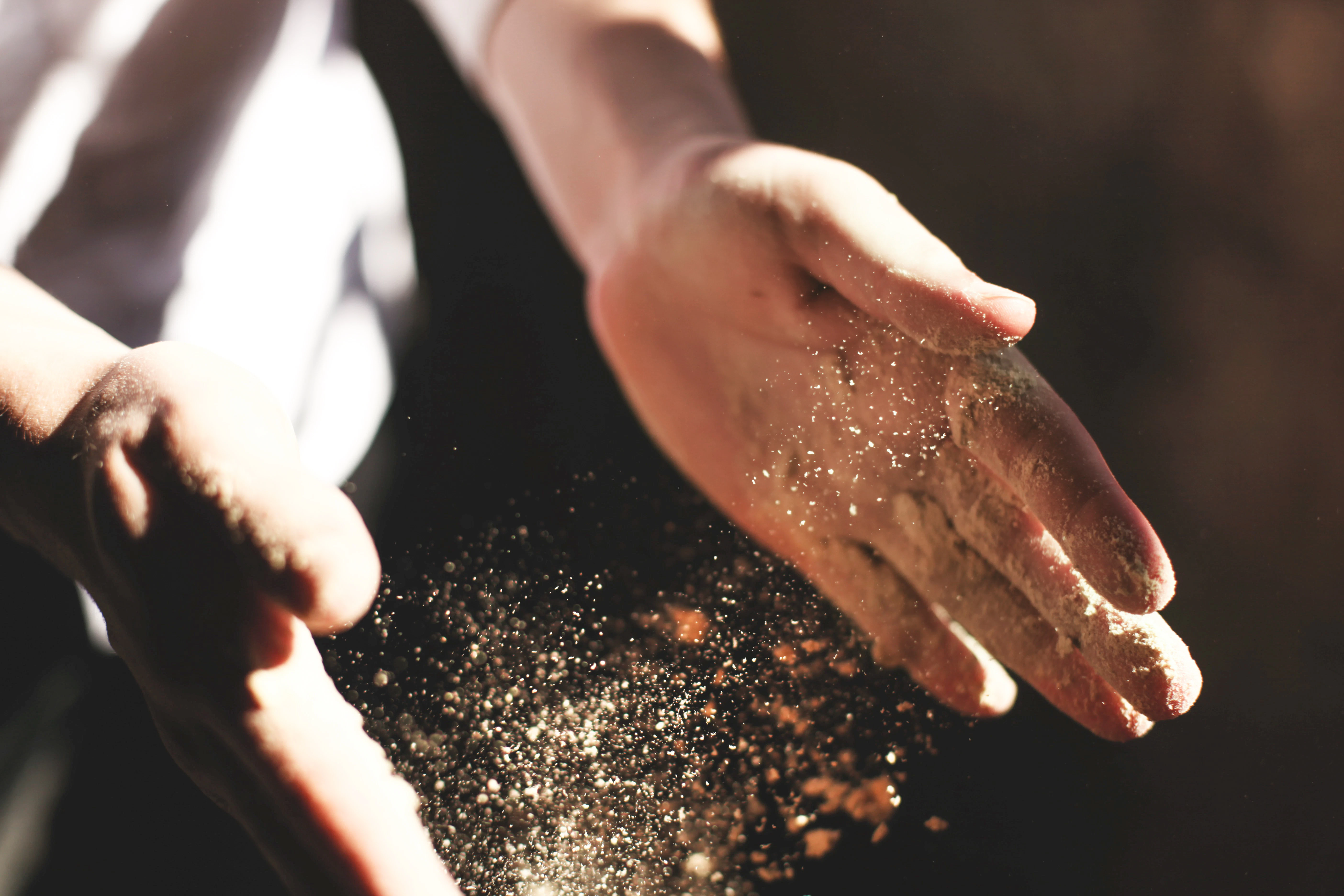 Flour hangs in the air around a baker's hands | Crosta & Mollica