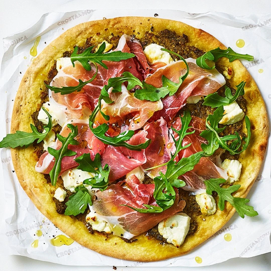 A close up of a Piadina pizza topped with Pesto, Prosciutto & Goats Cheese