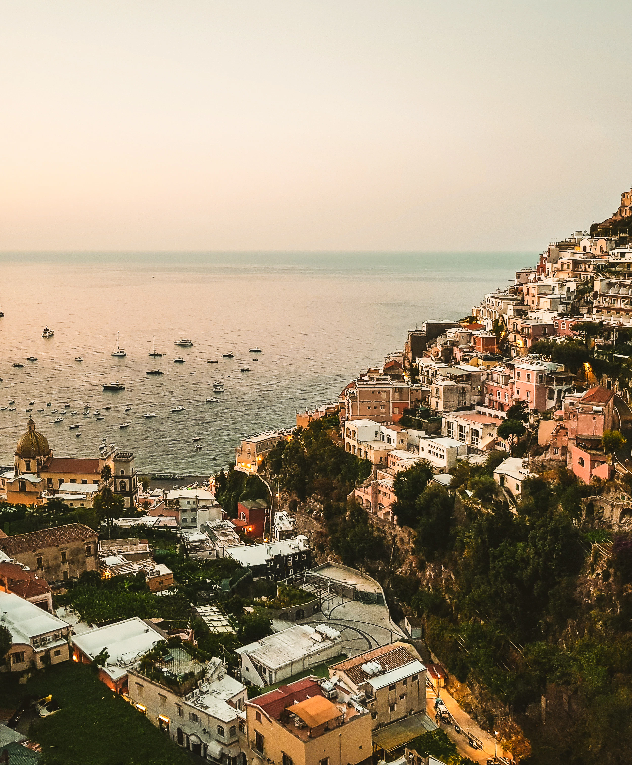 A village in on the Amalfi coast with the sea in the distance.