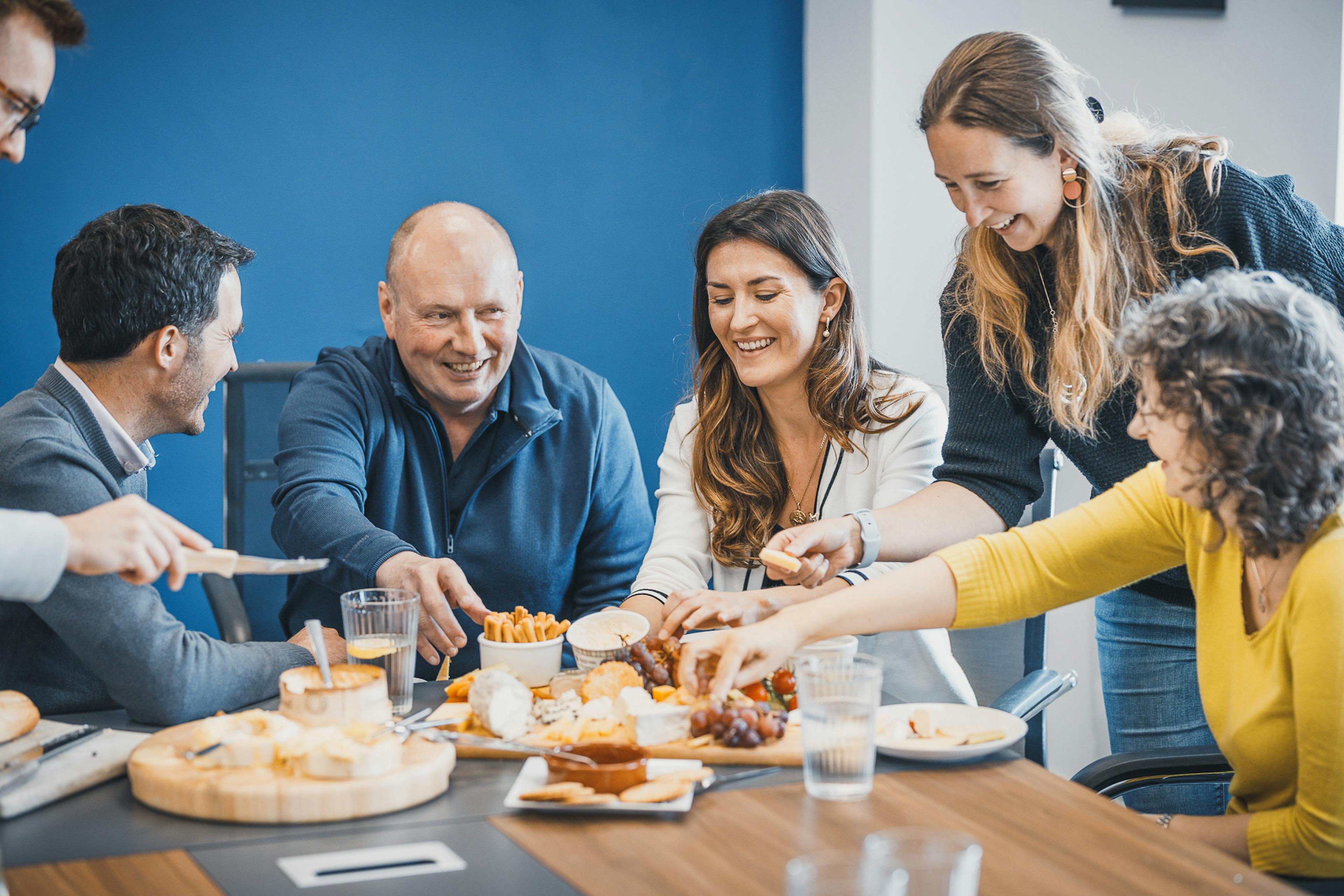 Group of people sharing a cheese board