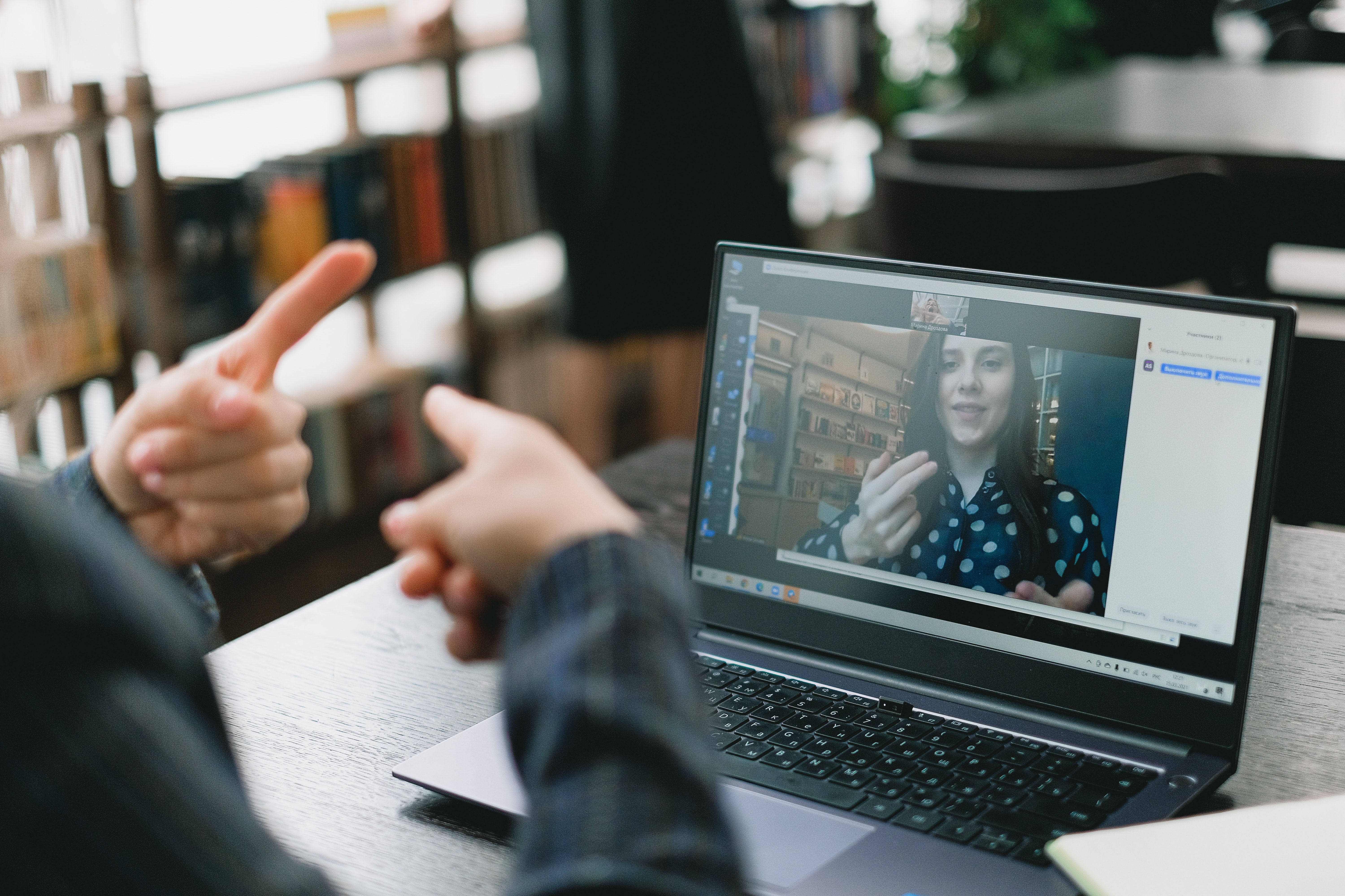 Student learning sign language during online lesson with female tutor