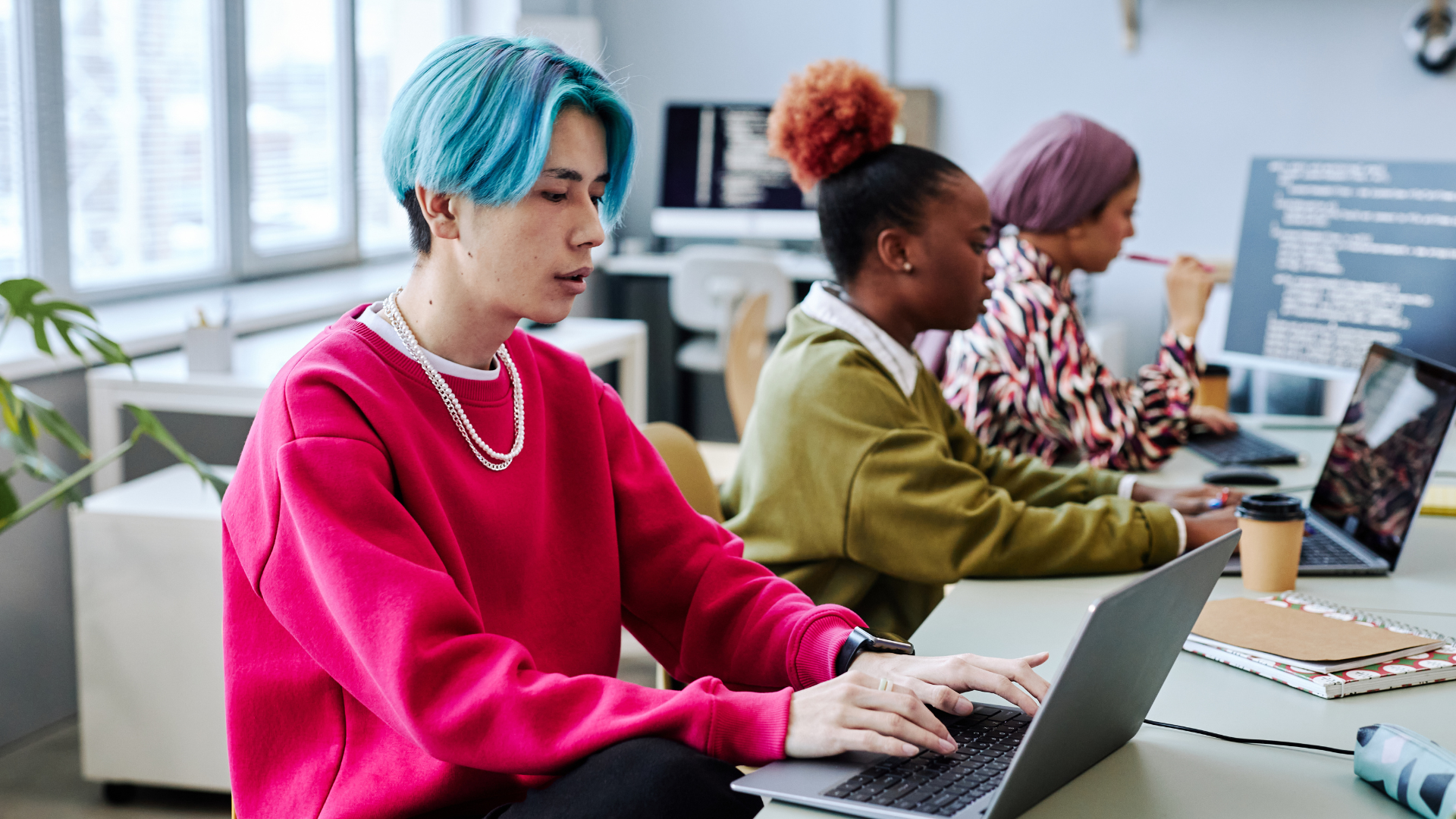 Two students on laptops studying