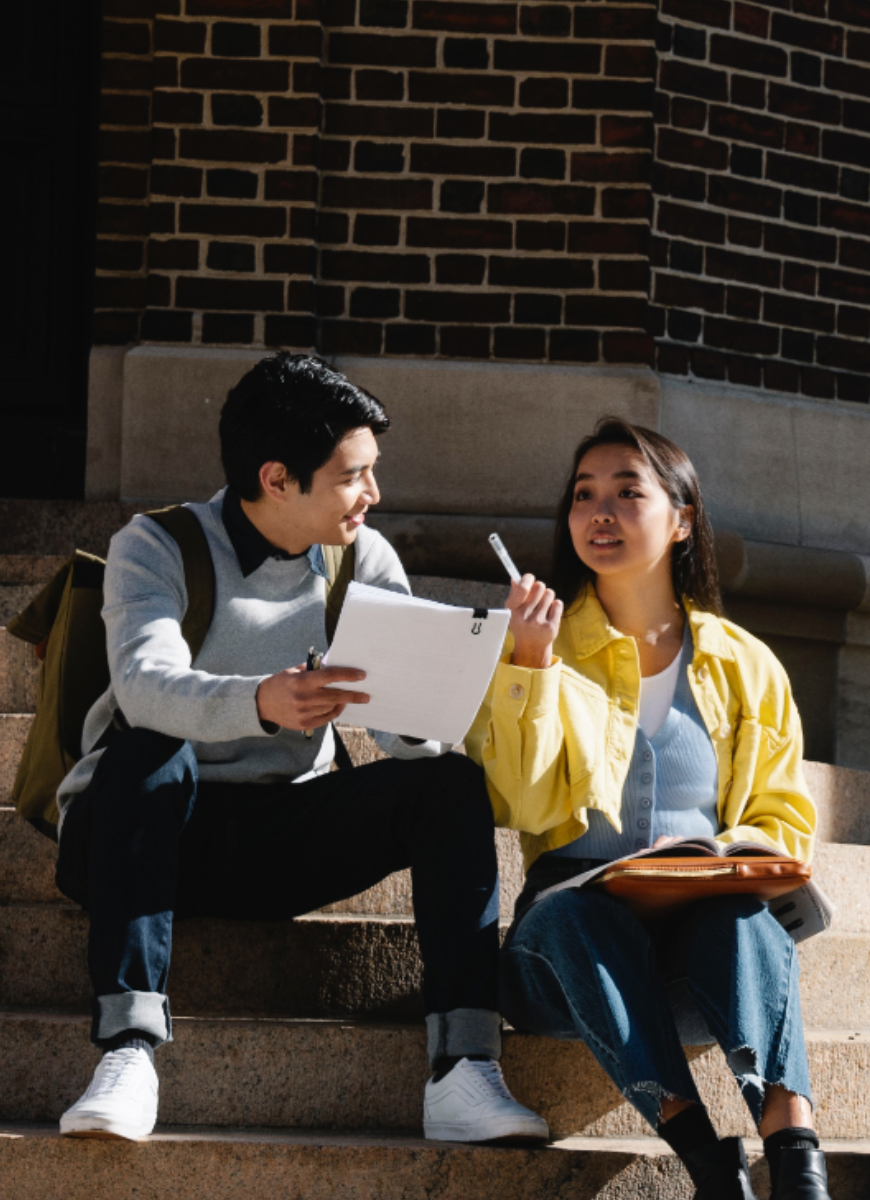 Students sat chatting on a step