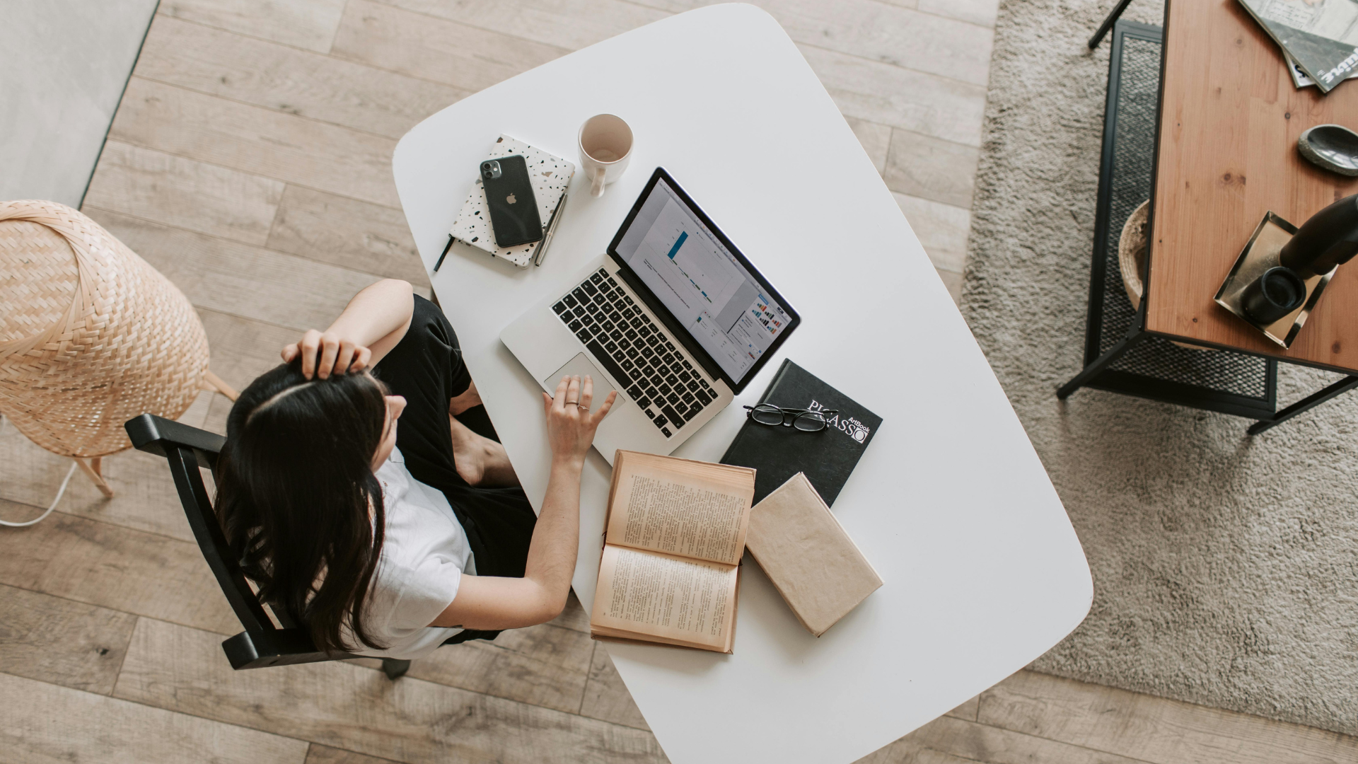 Girl studying at a laptop from a birds-eye view