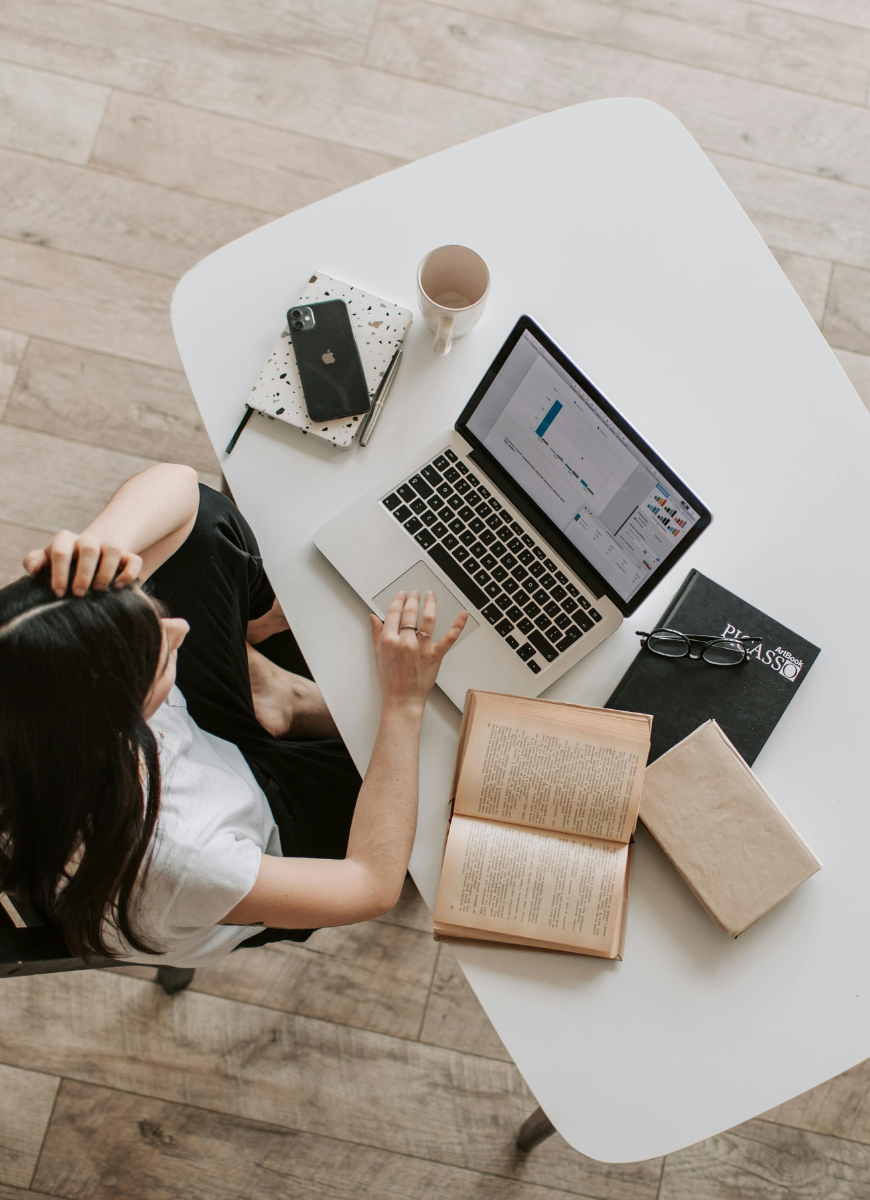 Girl studying at a laptop from a birds-eye view