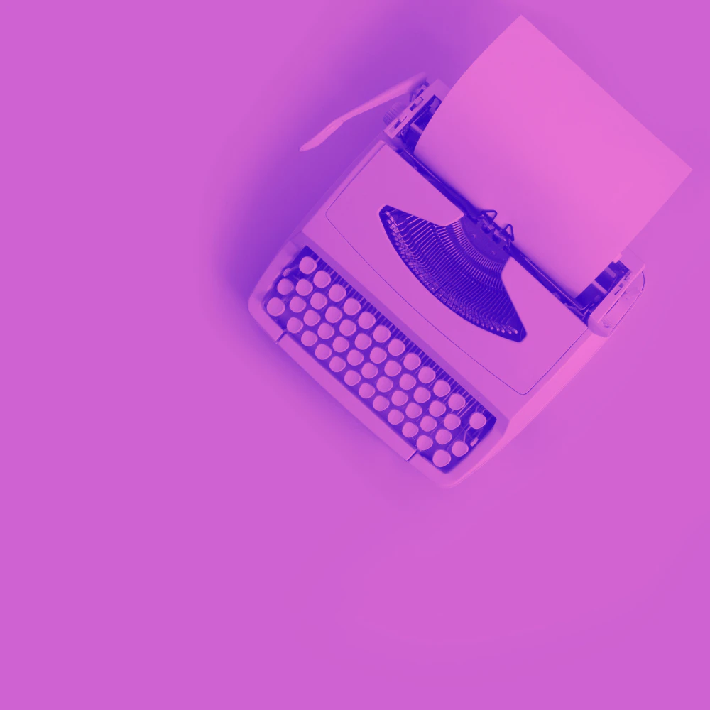 Pink typewriter on a pink background