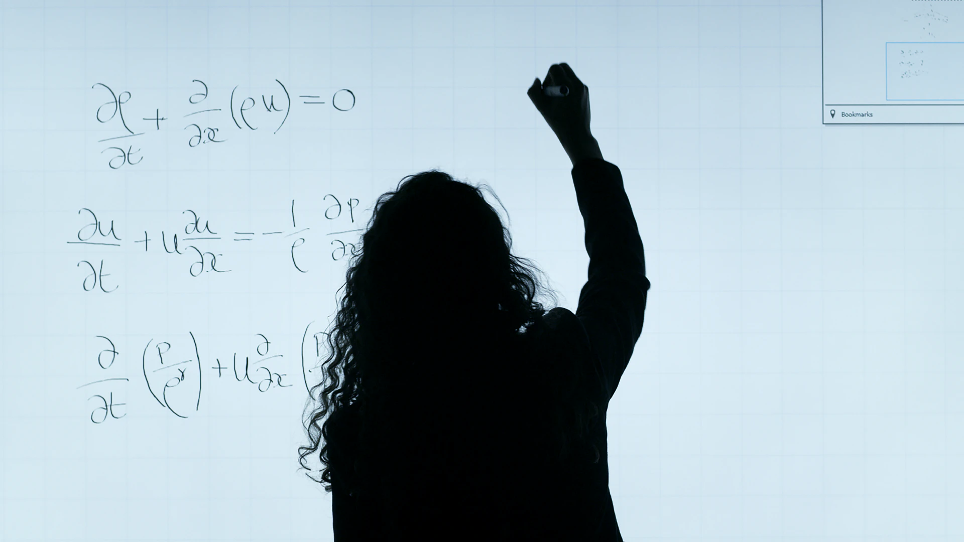 A person doing math on a whiteboard